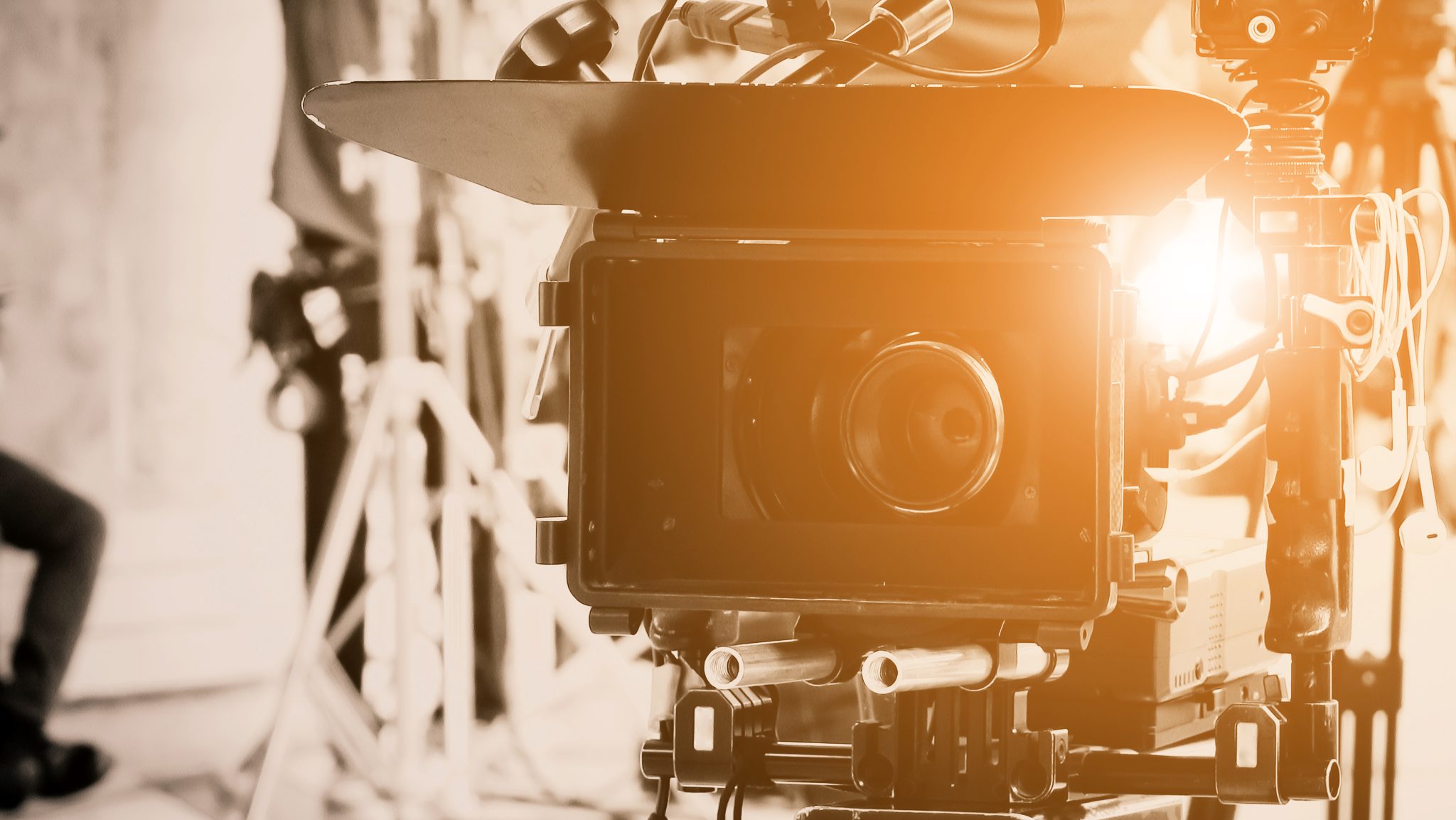 Close-up of a professional video camera setup indoors, capturing high-quality footage.